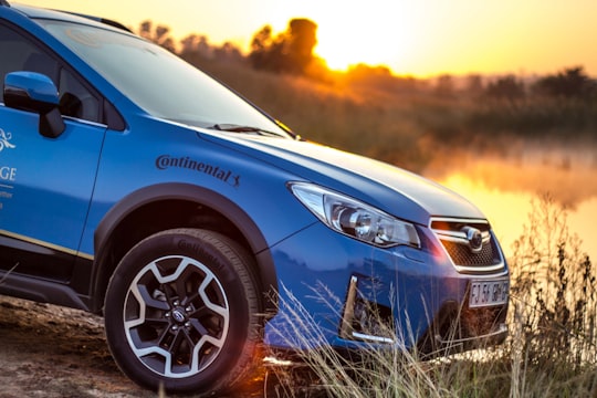 blue car near body of water in Johannesburg South Africa