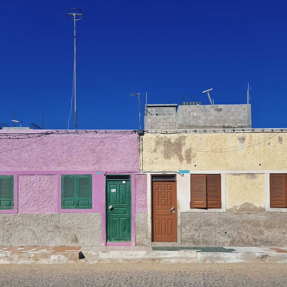 purple and yellow concrete houses during day time