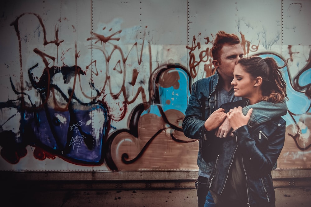 man hugging woman and kissing her on head