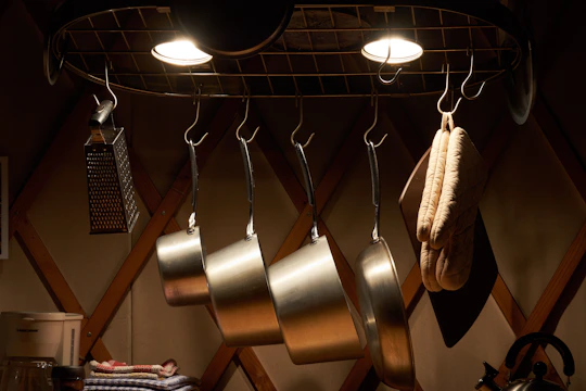 A bright kitchen scene featuring hand-dyed woven towels hanging from a wooden rack, sunlight catching the fibers.