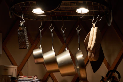 A cozy kitchen corner featuring a multi-tier stainless steel rack neatly holding spices and utensils.