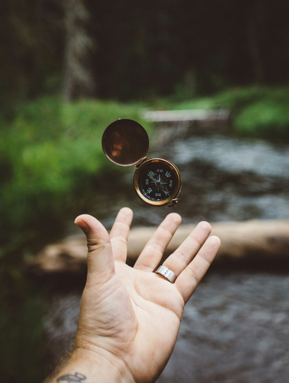 tilt-shift photography of person catching compass