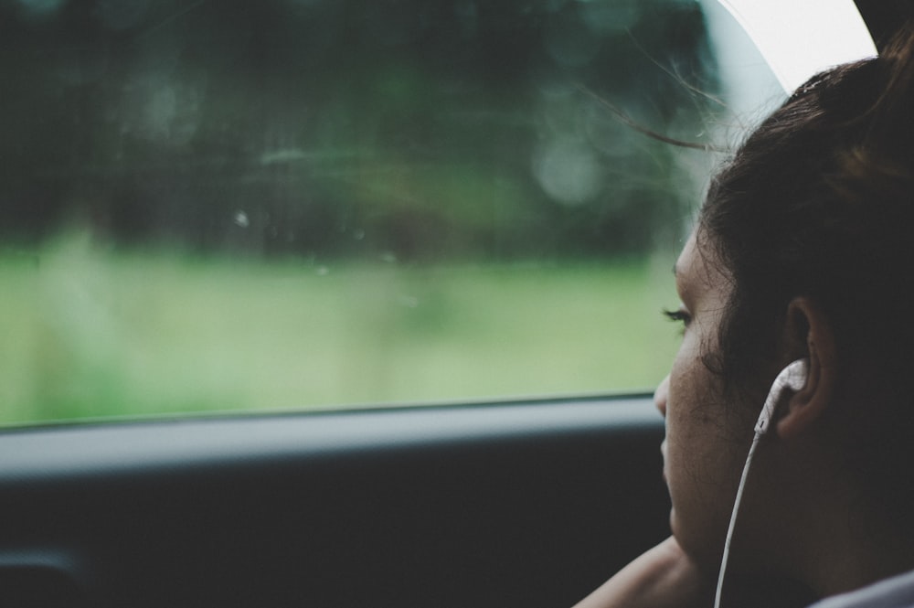 person wearing white earphones