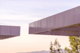 A cinematic aerial view of experimental structures blending seamlessly with the surrounding landscape.