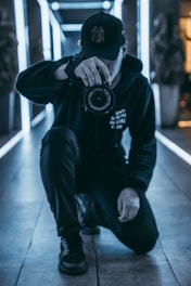man taking camera while taking picture inside building