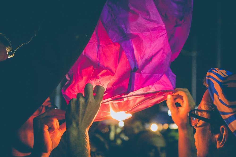 person's hand holding paper lantern