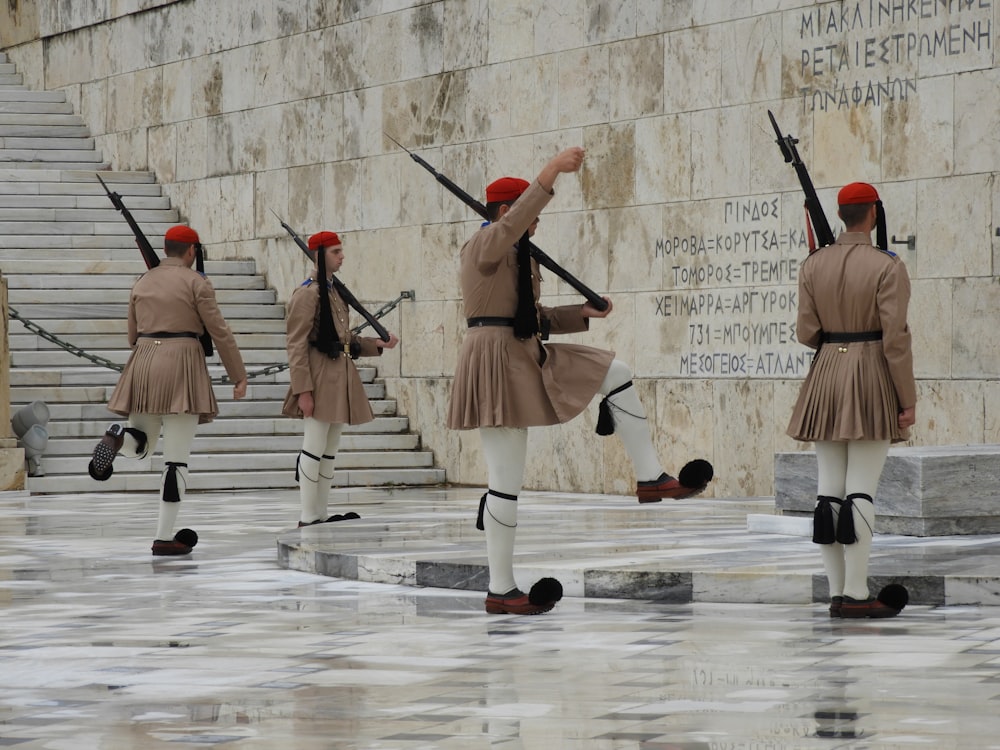 soldier wearing skirt standing infront of wall