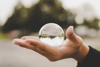 A calming image of hands gently holding a glowing crystal ball, symbolizing connection and insight.