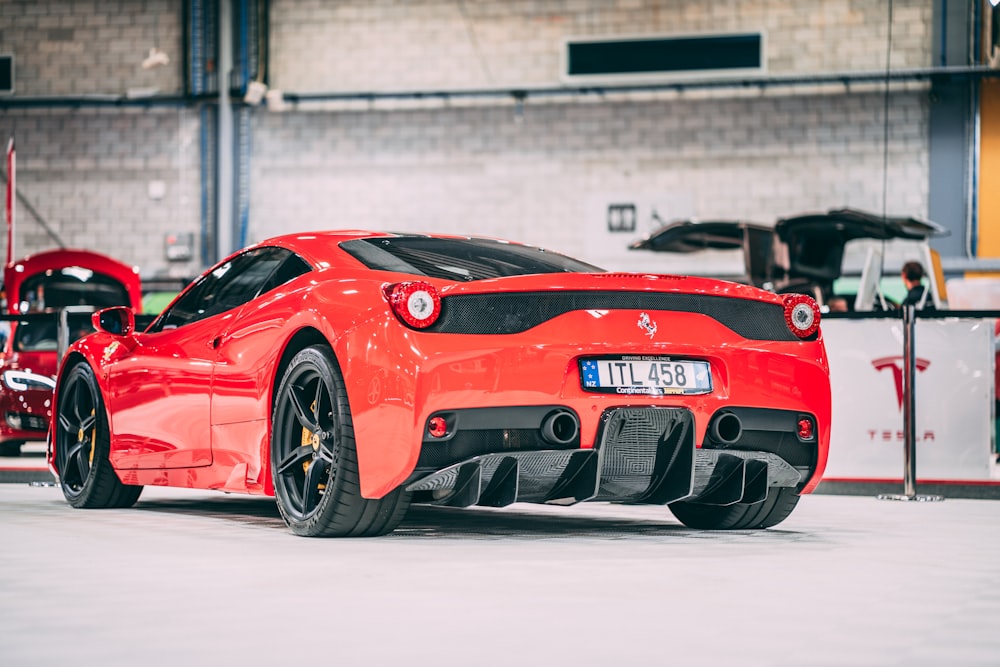 selective focus photography of red sports coupe