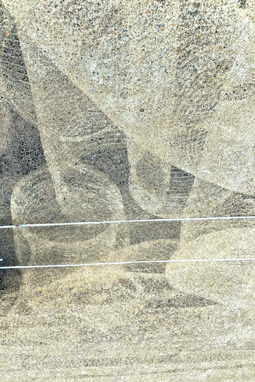A close-up of textured blue concrete with subtle light reflections, symbolizing the network's foundation.