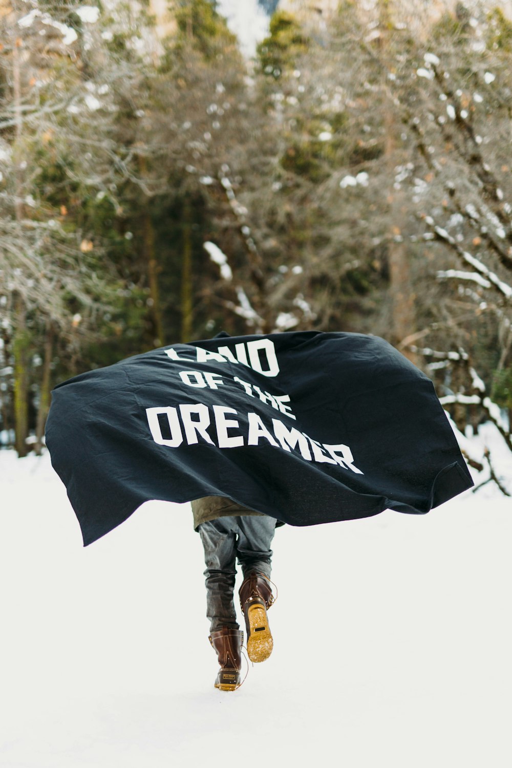 person running on snow with black textile