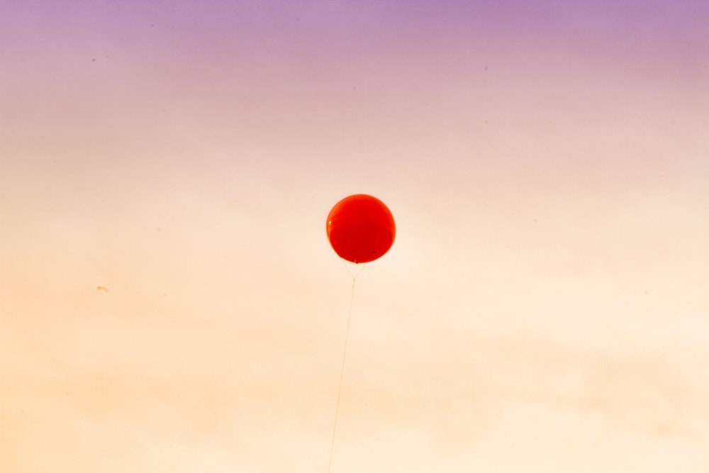 globo rojo flotando en el cielo