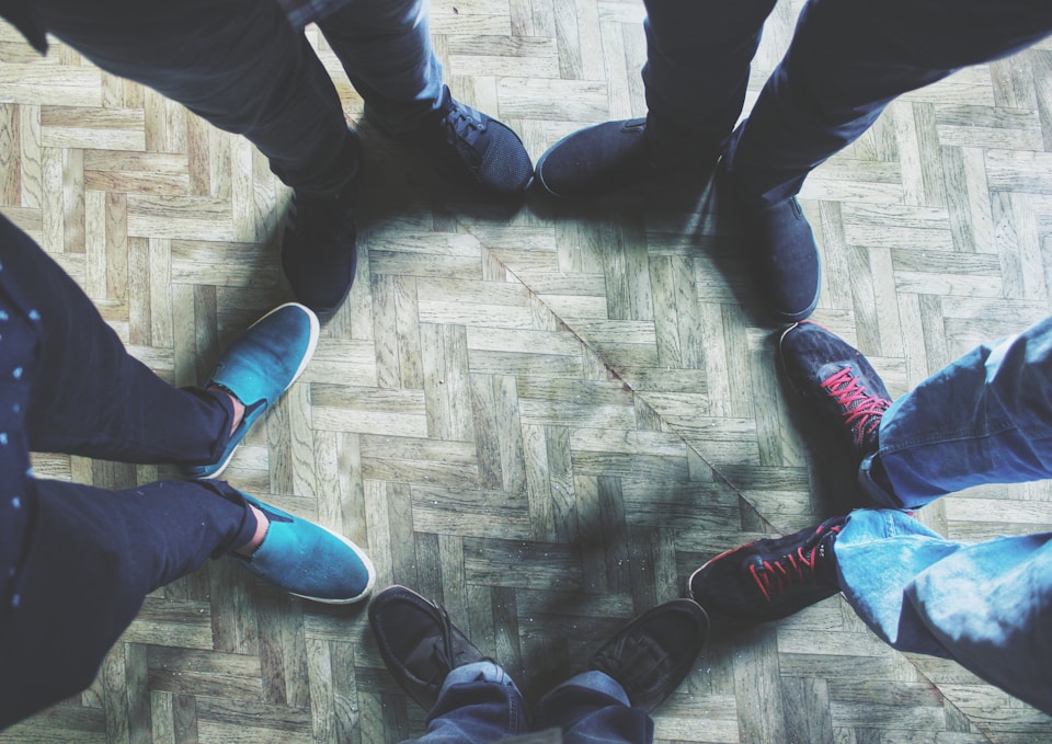Group of individuals in a supportive circle.