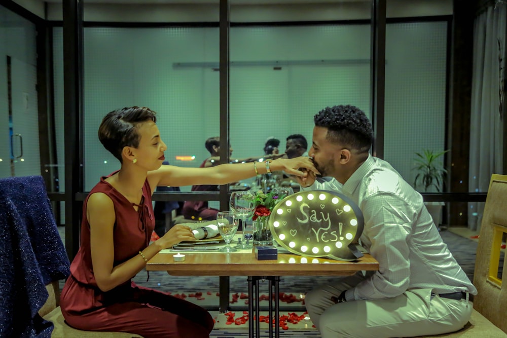 man and woman eating in diner