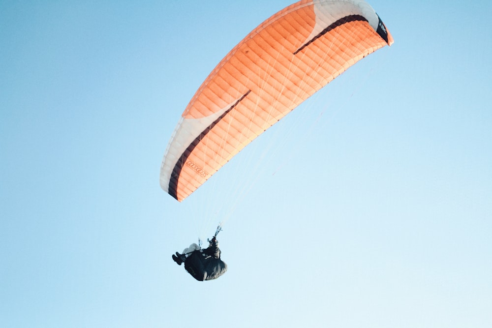 man wearing parachute in sky during daytime
