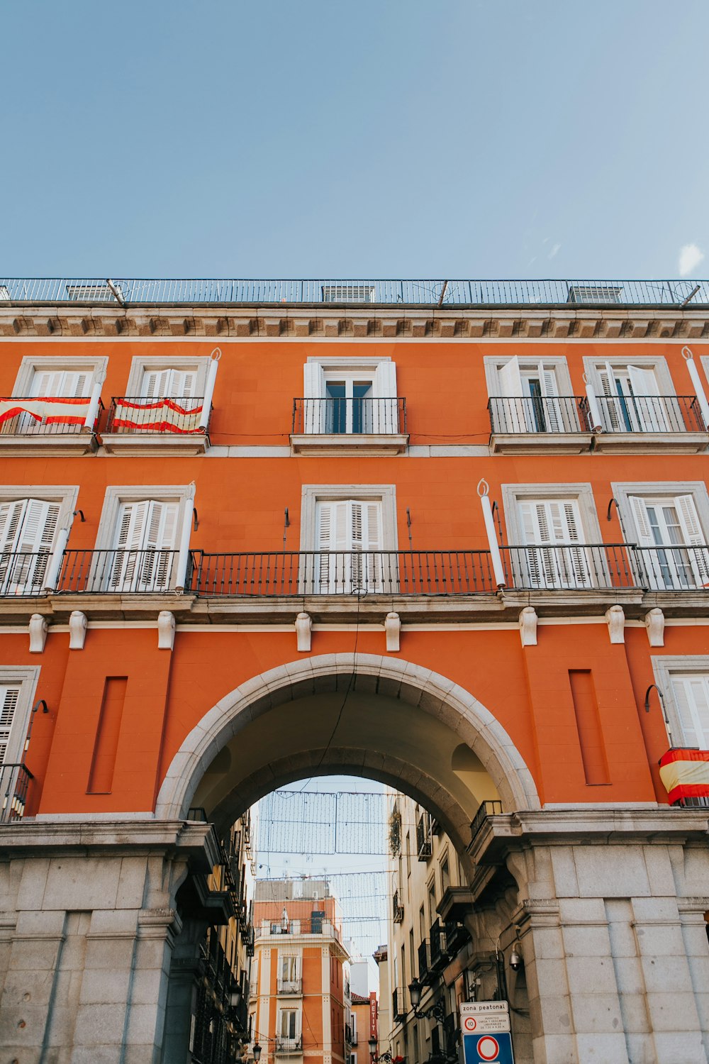 low-angle-photography of orange concrete building under blue sky