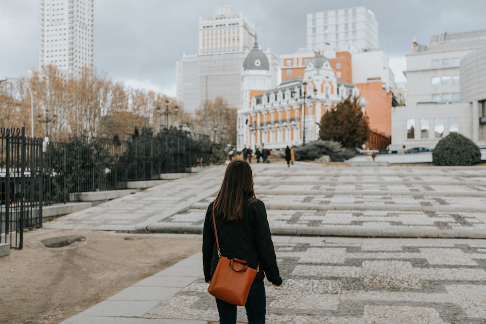 woman looking towards building