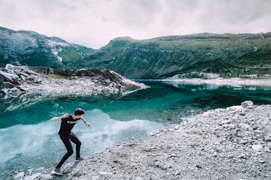 man trowing pebble in Ringedalsvatnet Norway