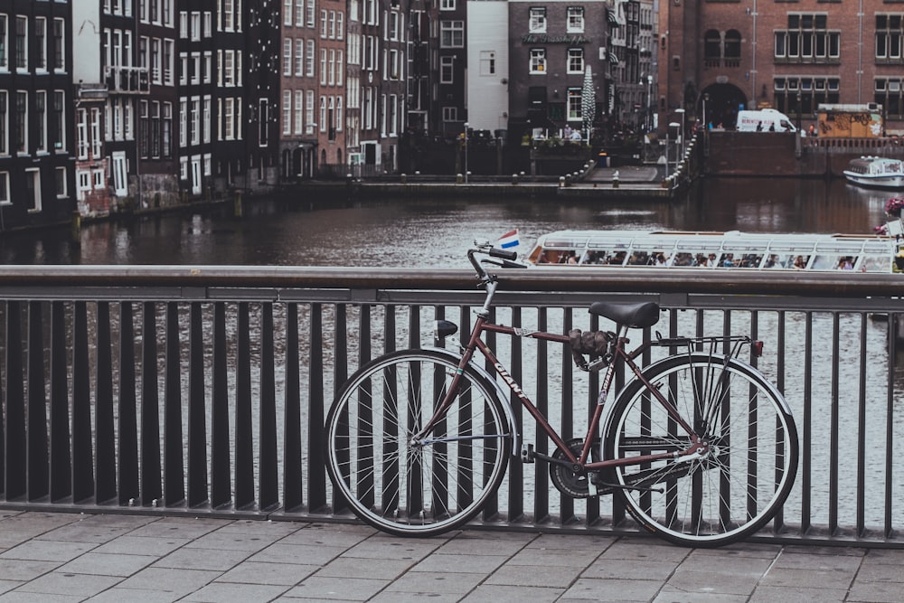 grayscale photography of commuter bike parking on gray metal handrails