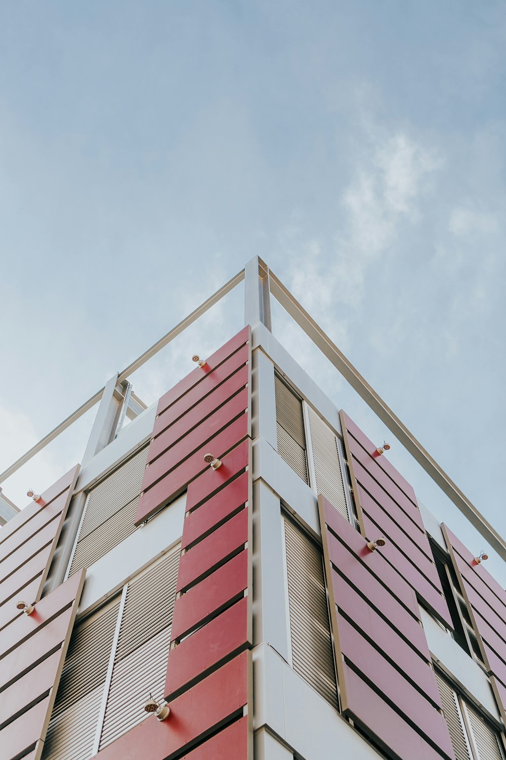 low-angle photography of red and beige concrete building at daytime