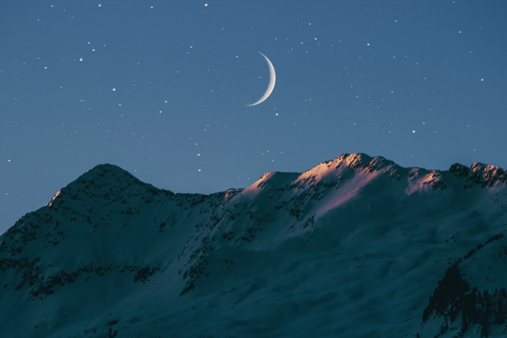 crescent moon above mountain