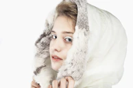 A cheerful mom smiling with a minimal makeup look, embracing her natural glow.