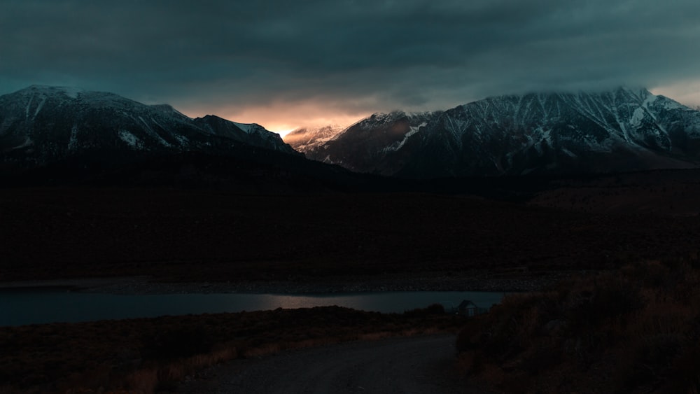 silhouette of mountains near body of water