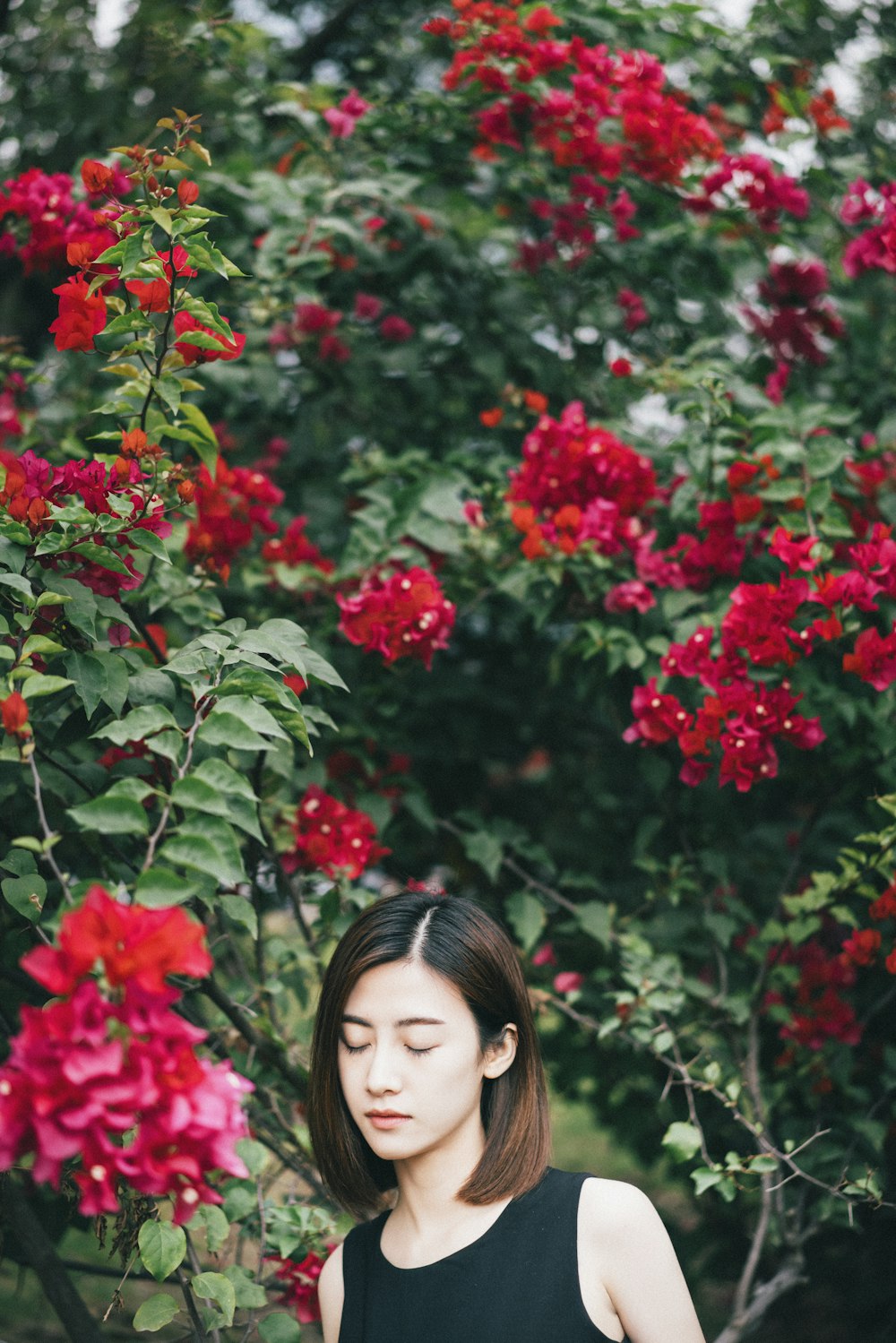 woman in black top closing her eyes