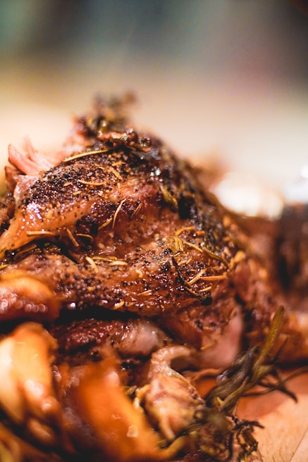 Close-up of a rich, savory main course with perfectly cooked meat and fresh herbs