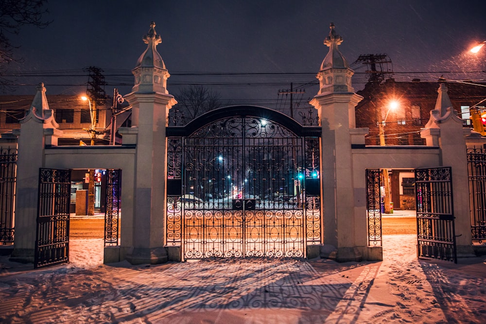 architectural photography of black metal and concrete gate