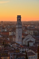 white concrete tower in a city during golden hour