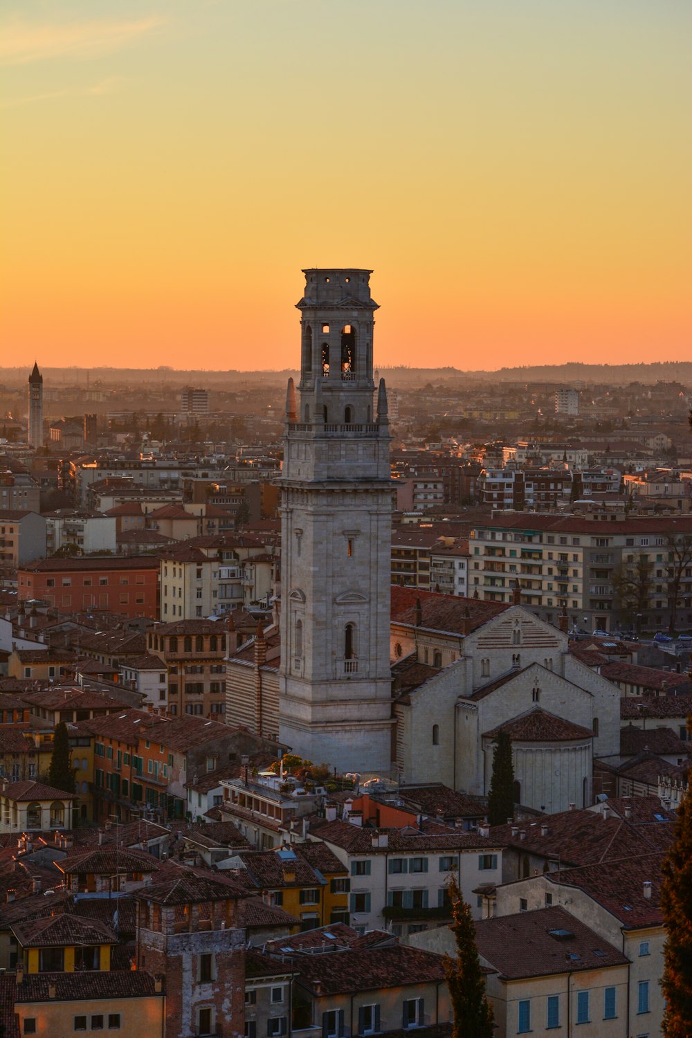 white concrete tower in a city during golden hour