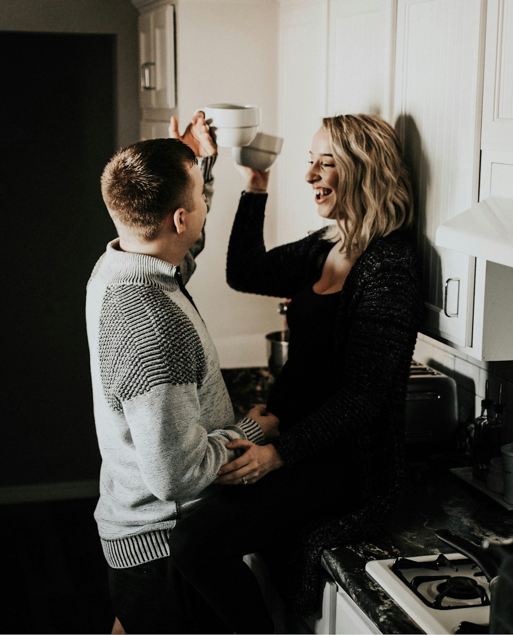 man and woman toasting a cups