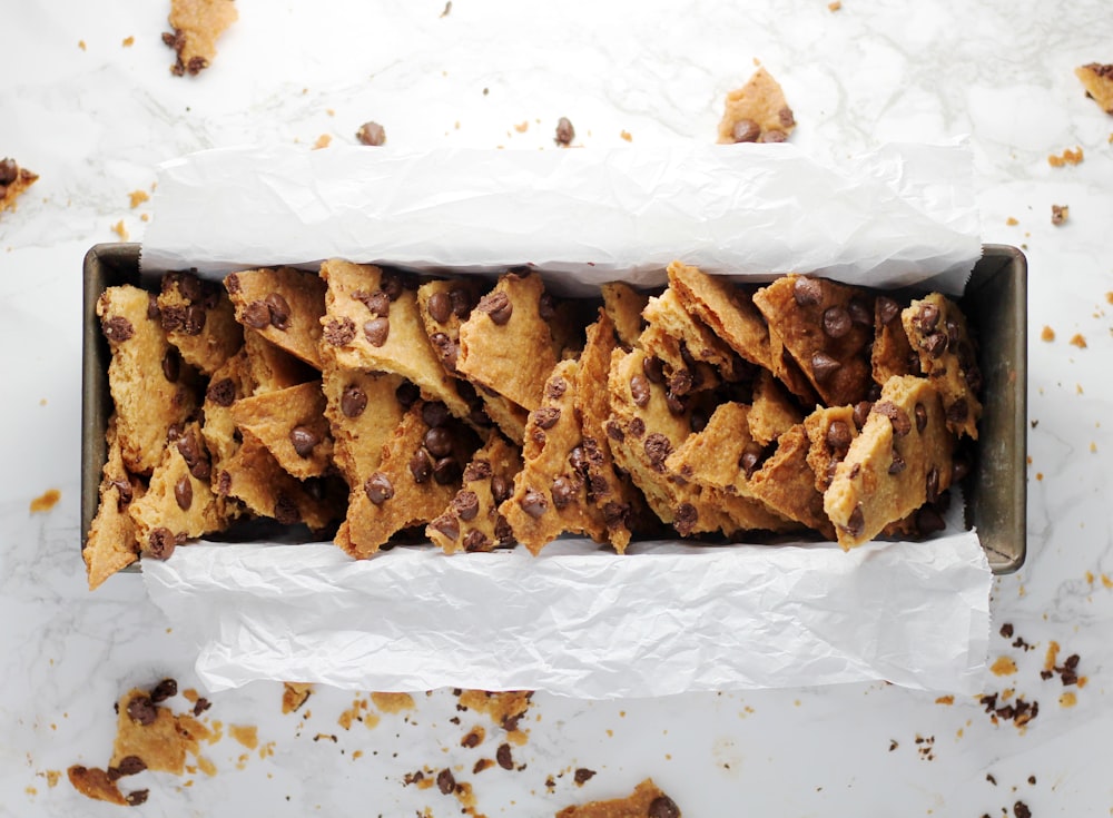 a box filled with chocolate chip cookies on top of a table