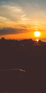 A vibrant sunset over a charming Spanish town.