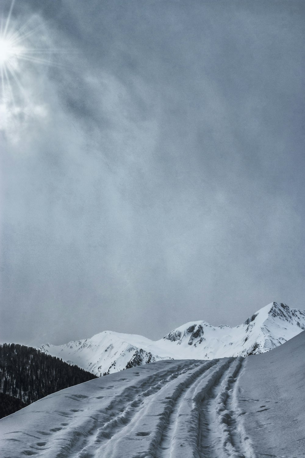 snow-covered mountain under cloudy sky during daytime