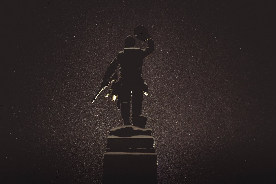 silhouette of statue against black background