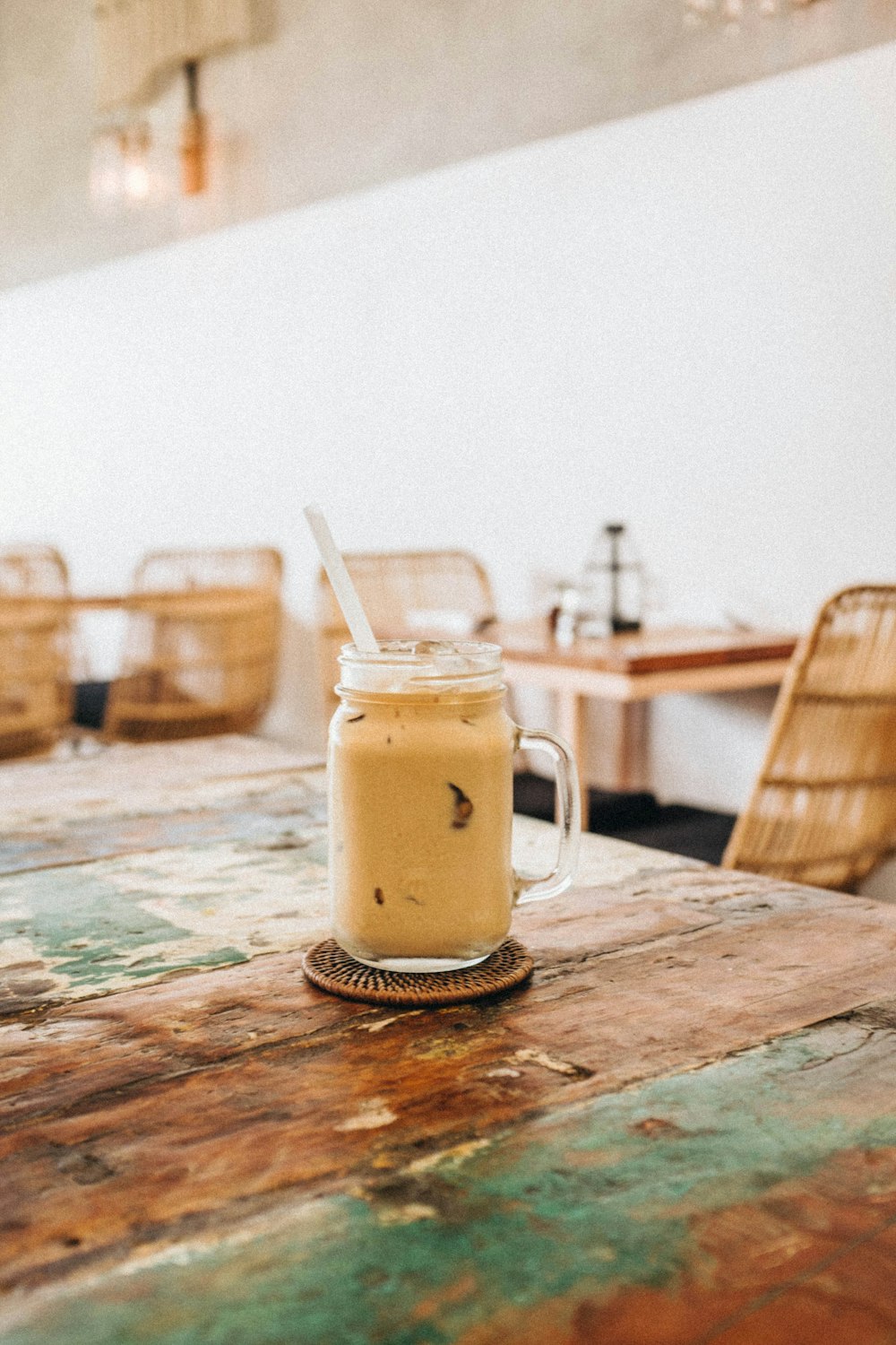 clear glass mug filled with liquid and straw