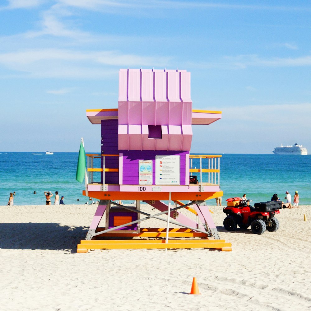 Casa salva-vidas rosa e multicolorida perto do oceano durante o dia