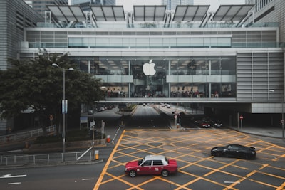 red and white car on parking area apple teams background