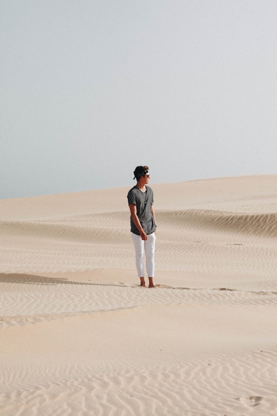 man in the middle of desert in Tarifa Spain