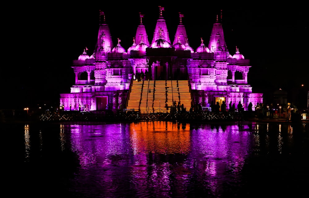 building with pink and orange lights at night