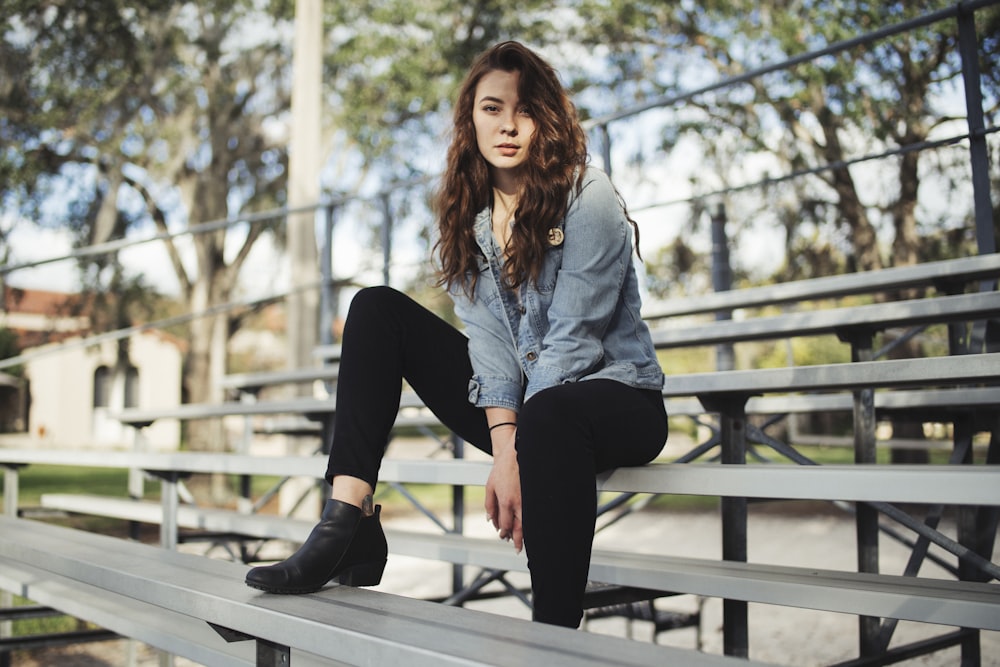 a woman sitting on a bench in a park