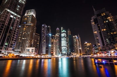 worm's eye view photography of city buildings at night