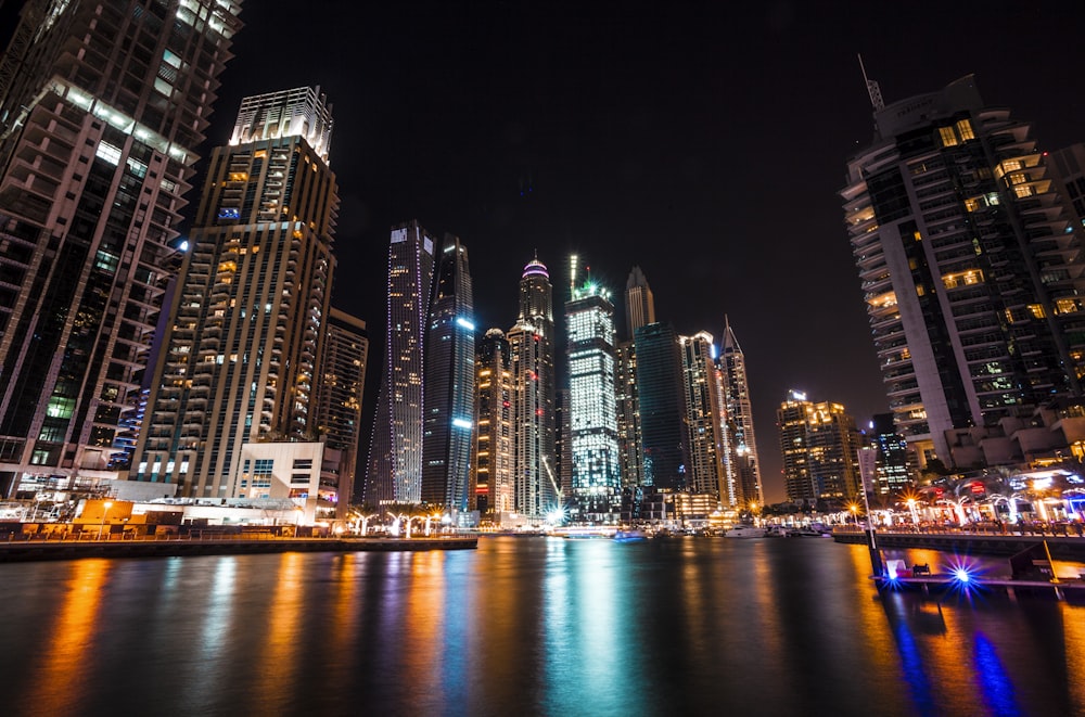 worm's eye view photography of city buildings at night