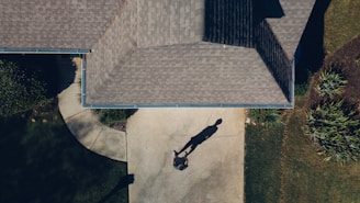 man standing in front of house during daytime