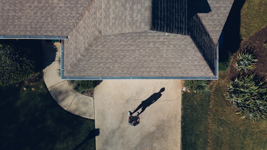 man standing in front of house during daytime