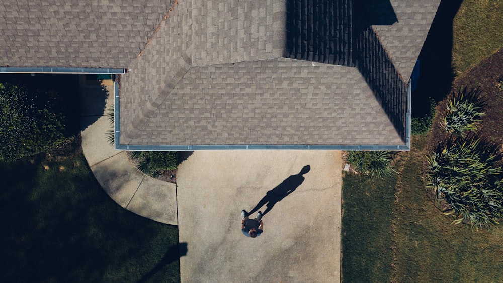 man standing in front of house during daytime