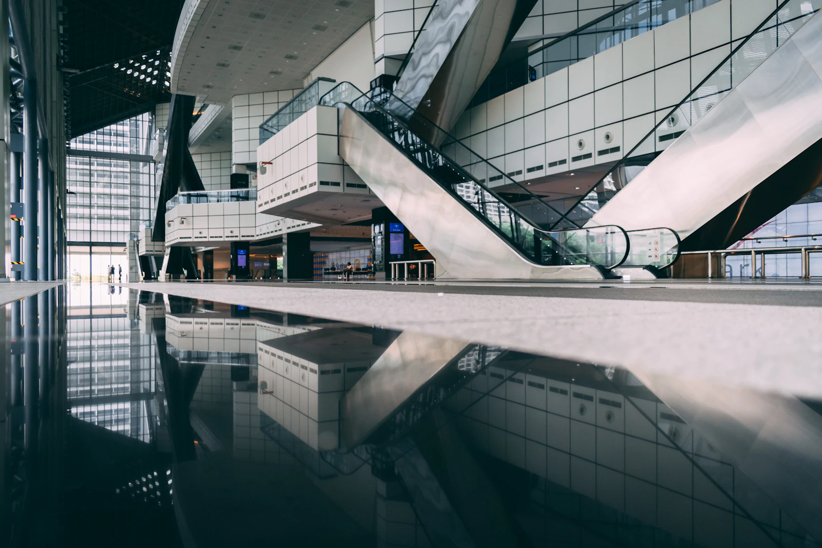 The bright concourse of a convention center before the doors open