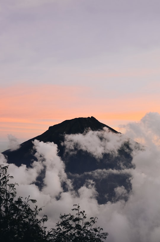 black mountain with white clouds during sunset in Mount Sundoro Indonesia